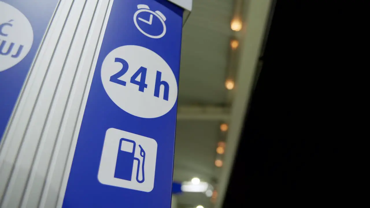 24h open sign located on a petrol station at night