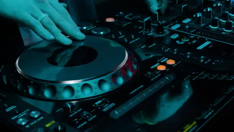 DJ using mixer at the disco