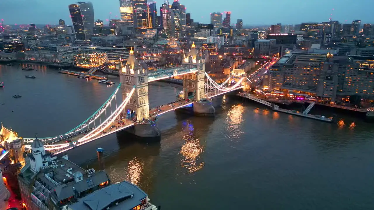 Orbital left to right drone shot of the Tower Bridge in London England during the evening