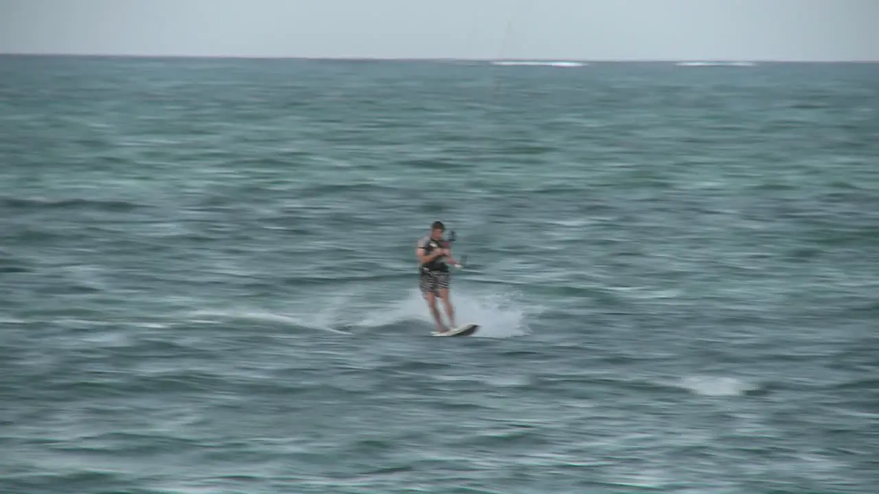 A windsurfer passes by