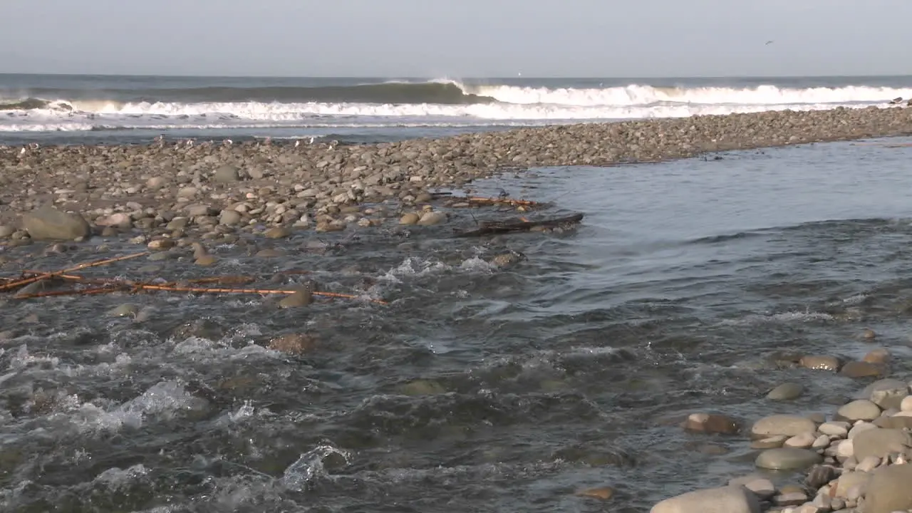 Water flowing out of the Ventura River estuary into the Pacific Ocean in Ventura California 1