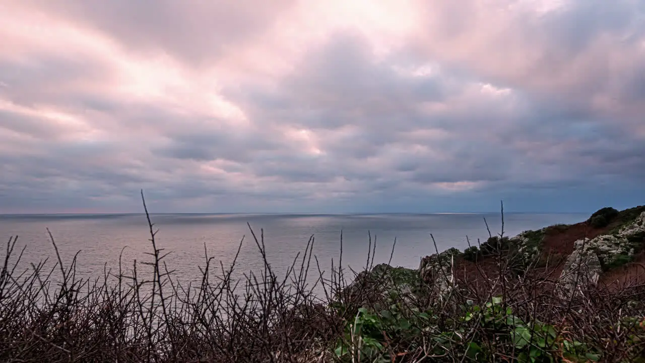 Hyper lapse shot of clouds movement above sea in rocky European coast