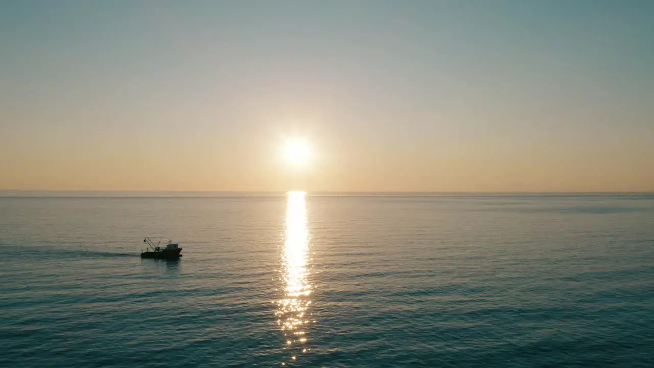 Industrial Fishing Boat Navigating In Tranquil Ocean During Sunset