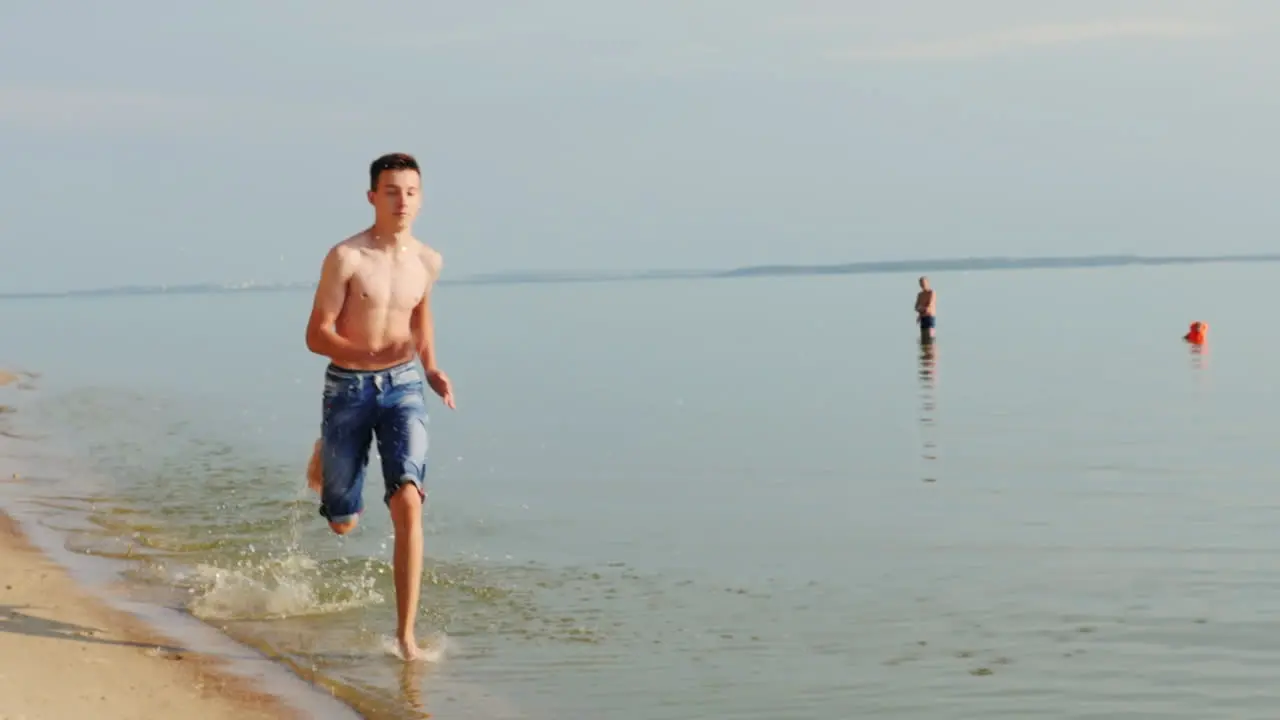 Teen 15 Years Running On The Beach On The Water Slow Motion