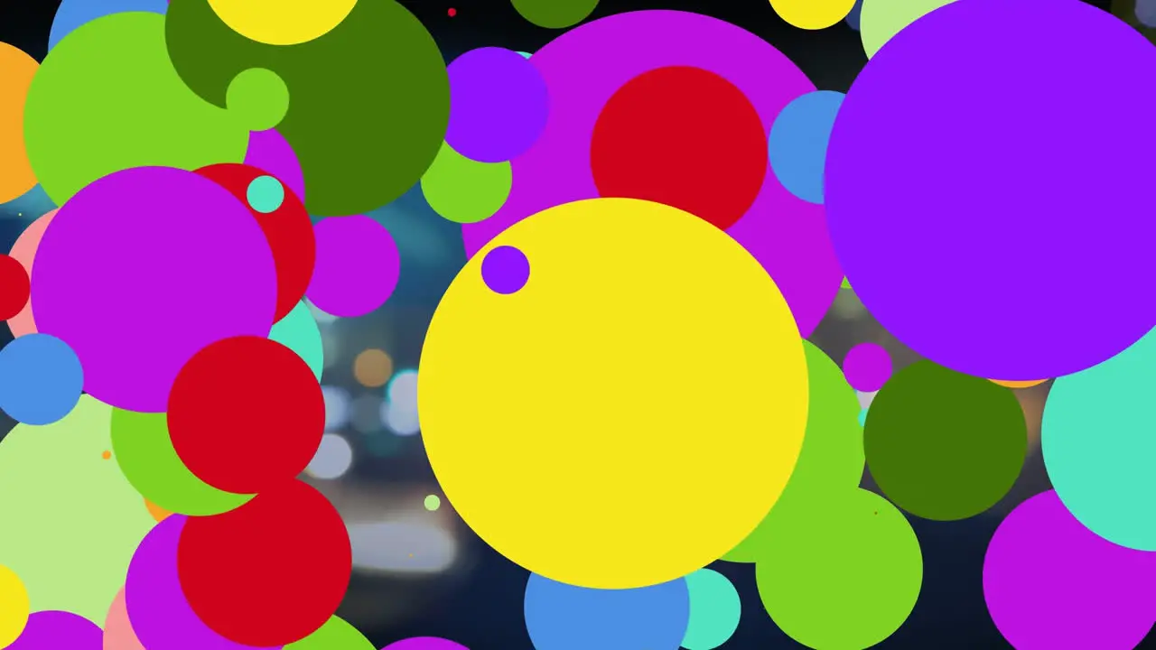 Animation of colorful dots appearing over blurred night city traffic