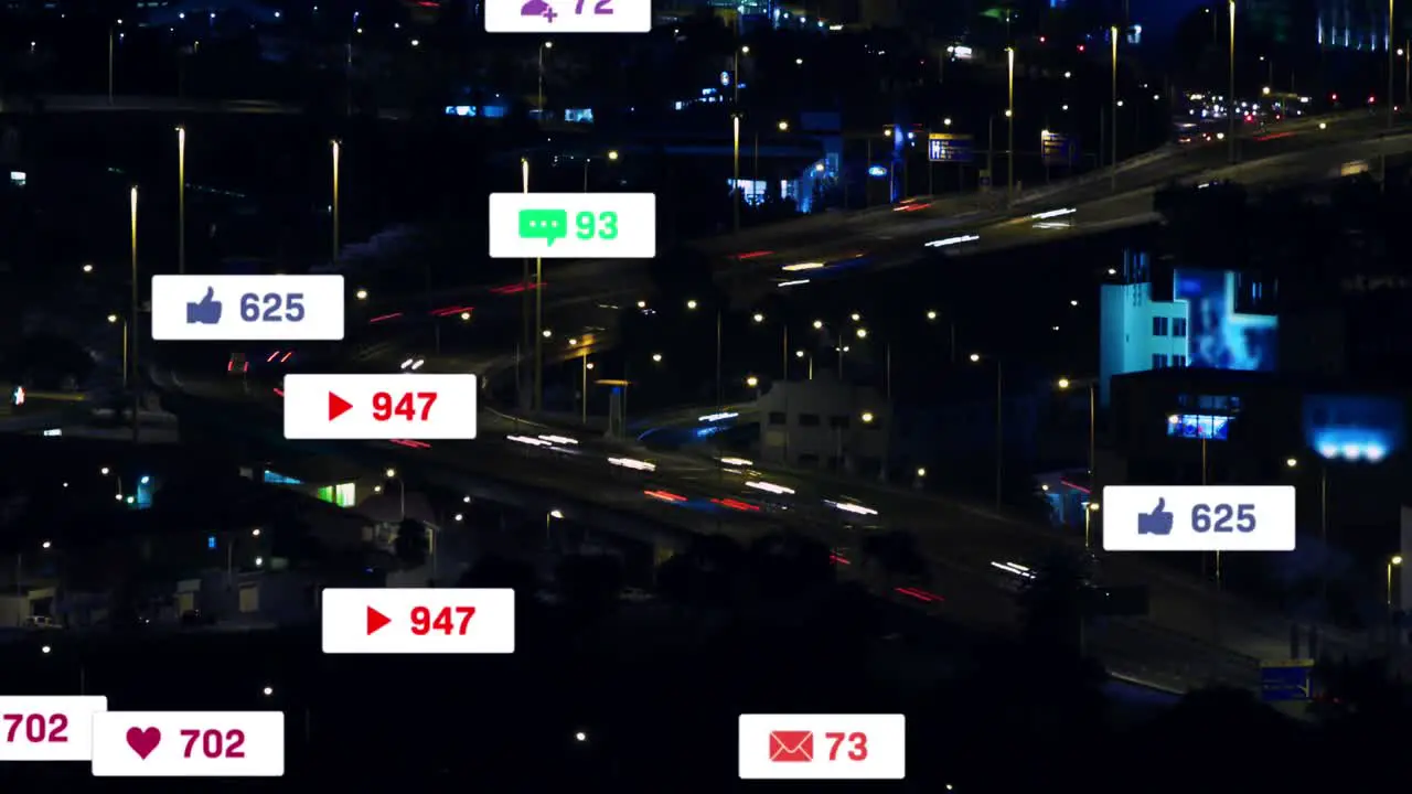 Animation of social media icons floating against aerial view of night city traffic