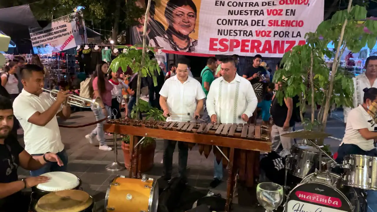 slow motion shot of a musical group a in the center of the city of oaxaca