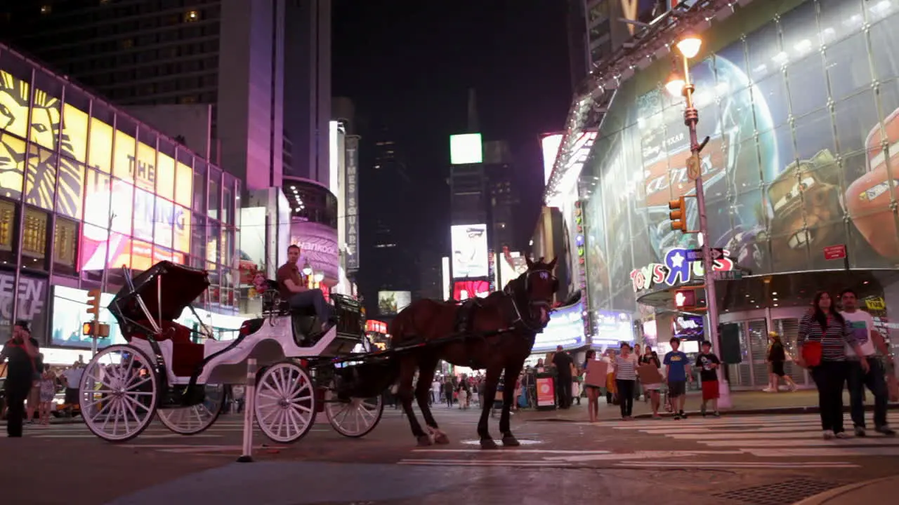 New York NY CIRCA 2016 A man in a horse and carriage eagerly awaits his next customer to explore Times Square in Manhattan