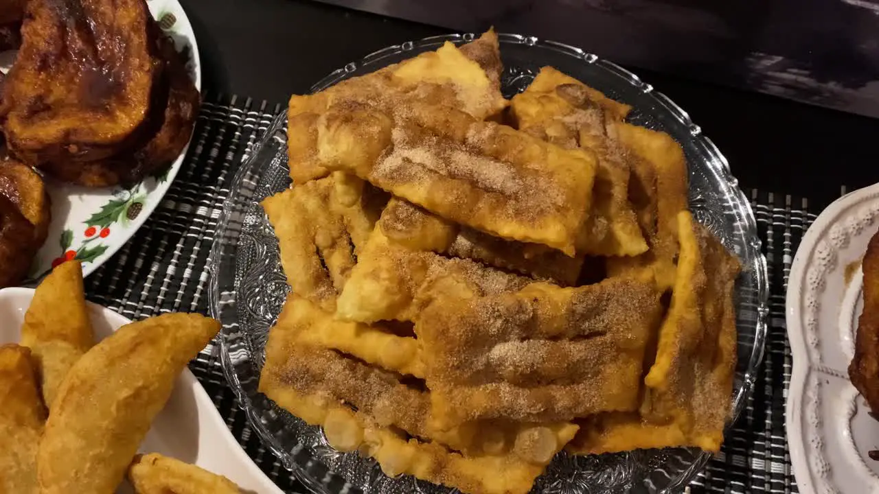 Traditional portuguese Christmas sweets Filhoses with sugar and cinnamon on kitchen countertop