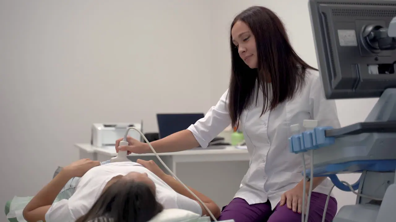 Doctora Haciendo Ultrasonido A Un Paciente Acostado En La Camilla Del Hospital