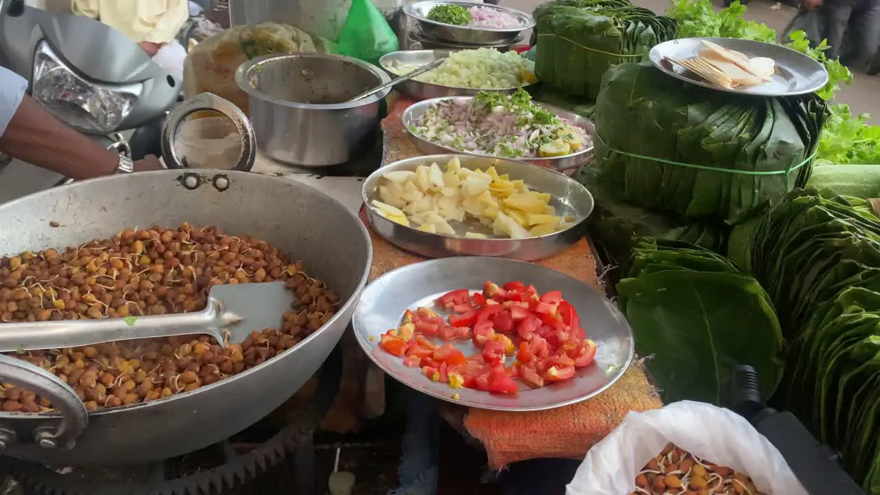 A Basket of a mobile Chana Chaat seller with tomato onion and sal leaves on display