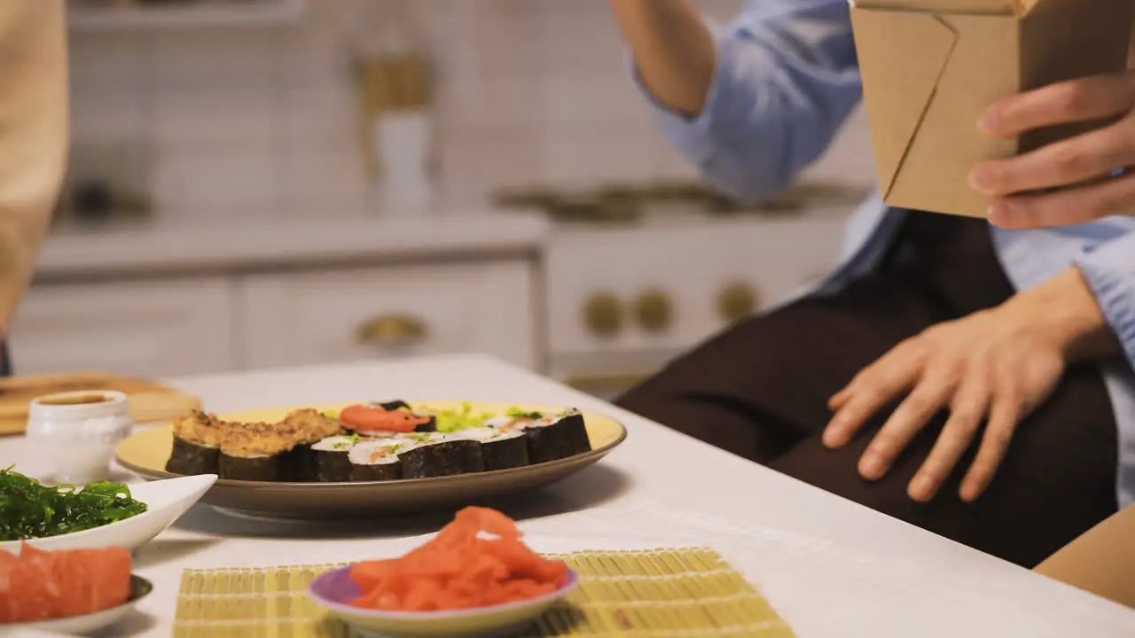 Close Up View Of A Woman's Hands Holding Chopsticks And Picking Takeaway Ramen