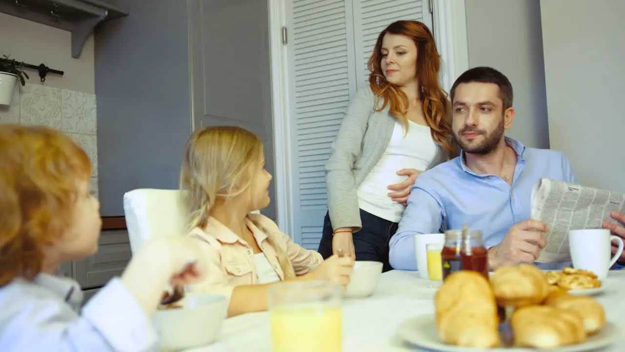 Family Having Brakfast In The Kitchen