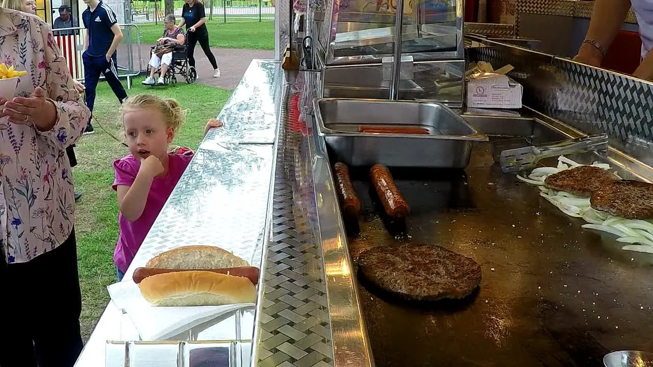 Serving customer fries from a food van