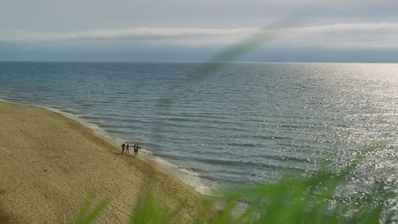 Serene nature ocean landscape beach People walking by blue sea water shore