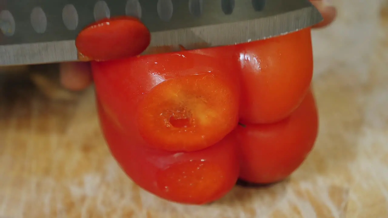 Motion controlled slow motion shot of cutting red paprika