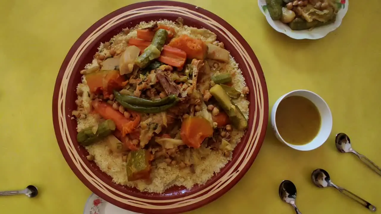 Couscous meal with meat and vegetables in a traditional Arabic plate Morocco 