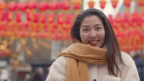 Portrait Of Smiling Young Asian Woman In Chinatown London UK 1