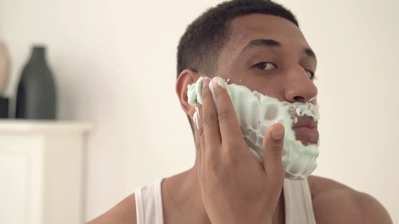 Portrait Of Handsome Black Man Applying Shaving Foam