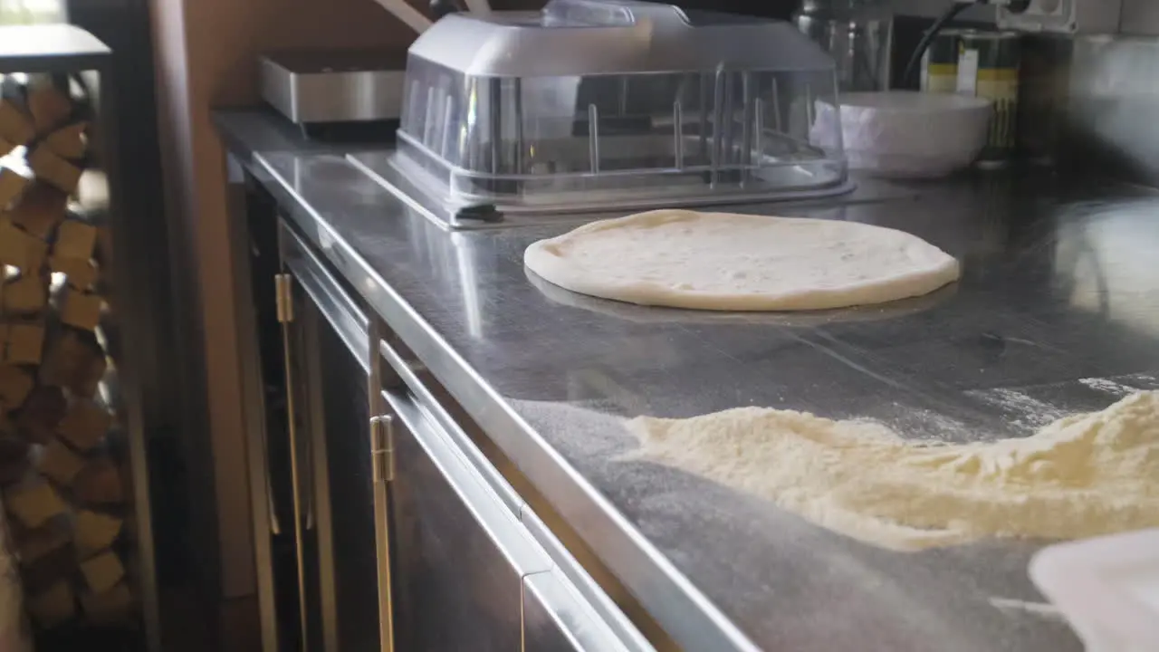 Close Up View Of Flour And Pizza Dough On A Restaurant Kitchen Countertop