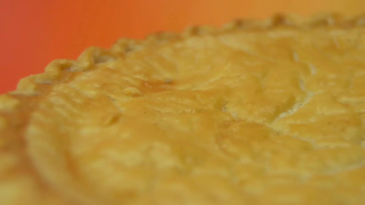 [Camera Used Canon C300] Close-up the golden crust of a rotating cherry pie