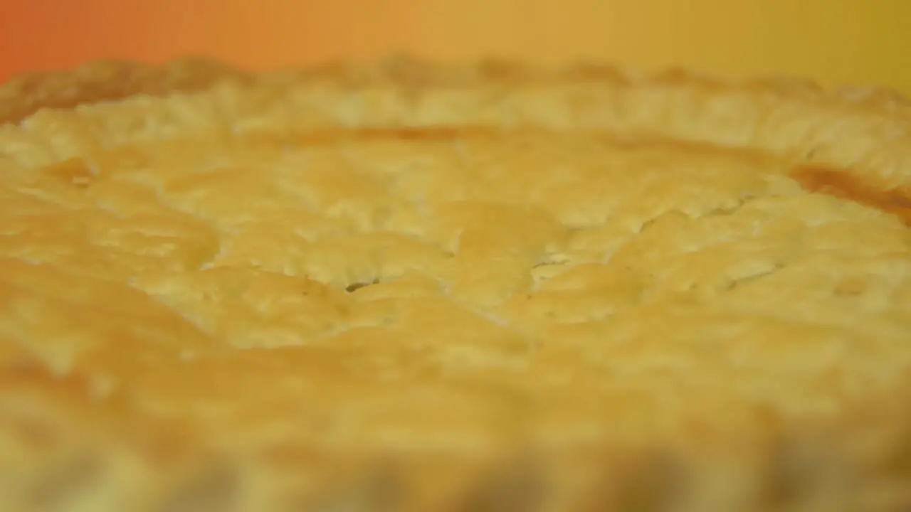 [Camera Used Canon C300] Close-up rotating golden pie crust