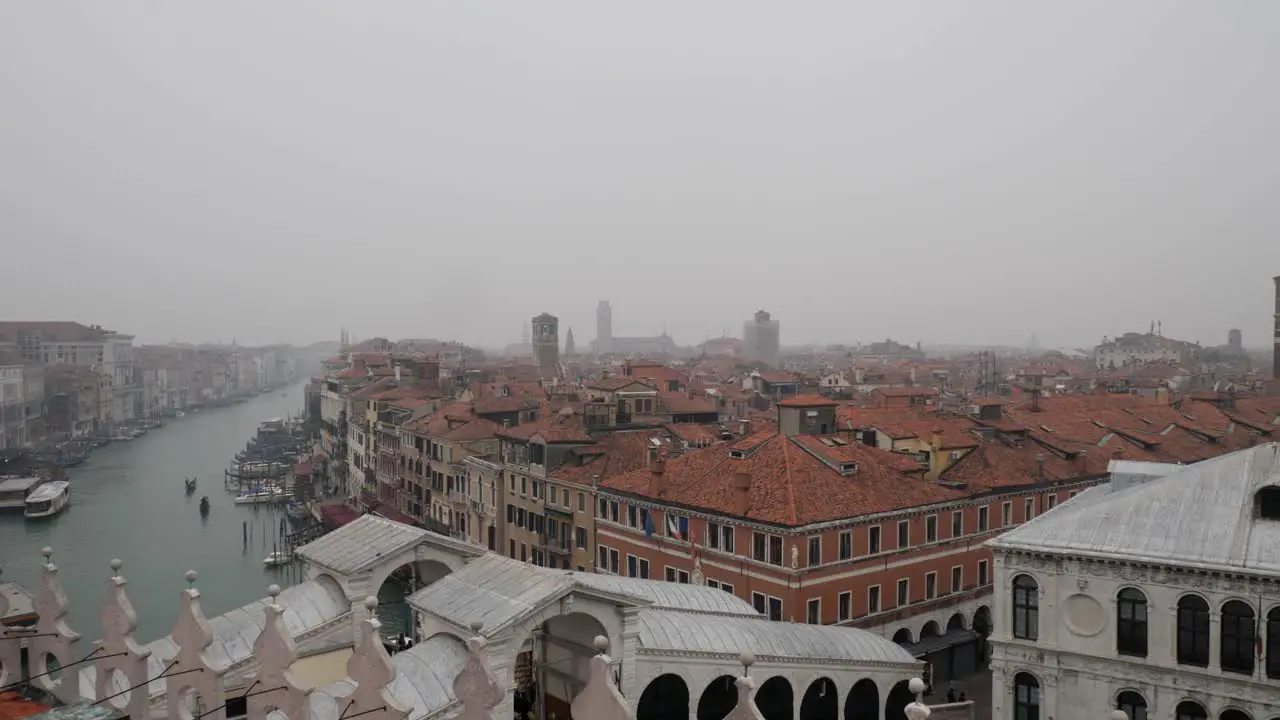 Panning shot of Venice from the terrace of Rialto Hotel on a misty cloudy day