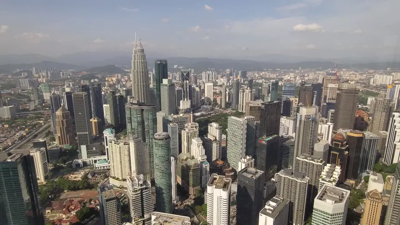 Panning shot of Kuala Lumpur and Petronas towers from the sky