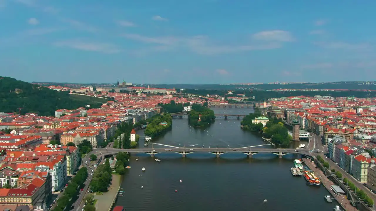 Prague bridges aerial view during hot summer day with boats over the Vltava river