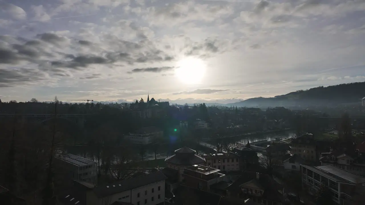 Timelapse of clouds passing over Bern city with smoking house chimneys