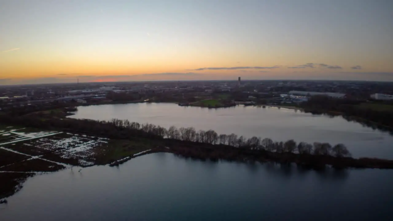 Beautiful lake on city side during sunset time aerial hyper lapse