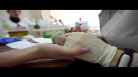 Closeup view of blood analysis from finger Medical hand taking blood from finger Finger needle puncture Test blood sample Shot in 4k