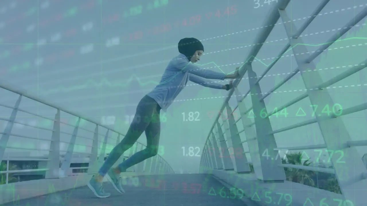 Animation of stock market data processing over biracial woman in hijab stretching on the bridge