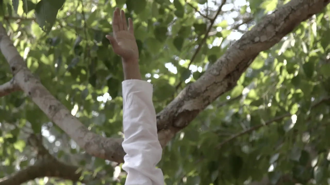 Asian man practices yoga poses in front of some temples