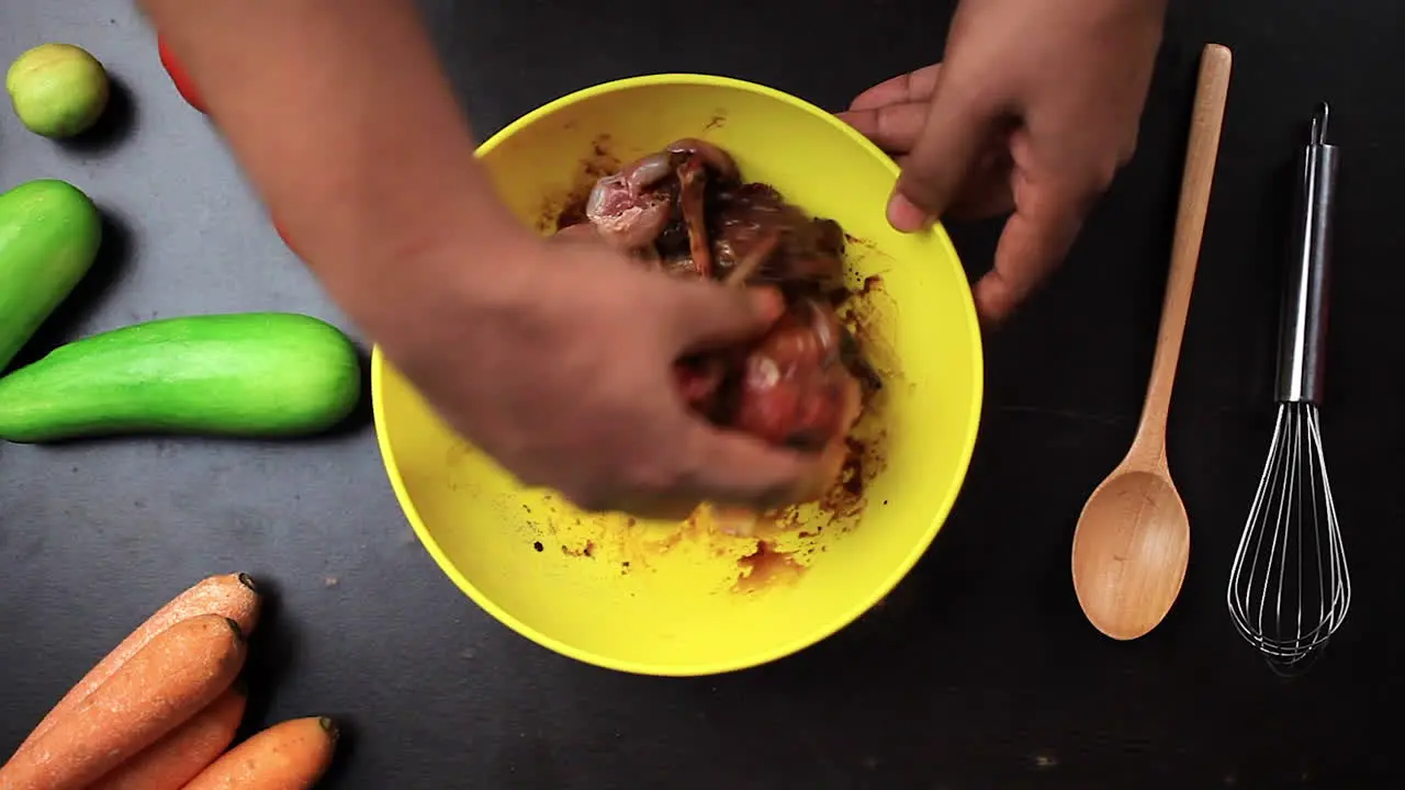 man mixing raw cutting chicken lollipop black pepper black soy sauce and salt