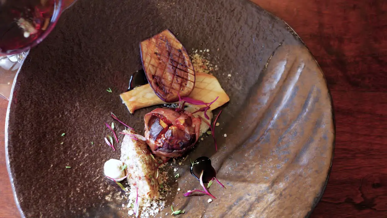 Top down view of aubergine mushroom fig fine dining with red wine