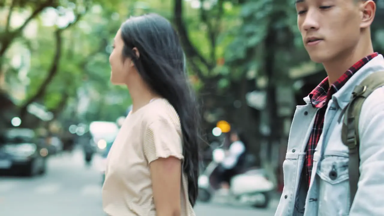 Handheld view of couple walking in the city street