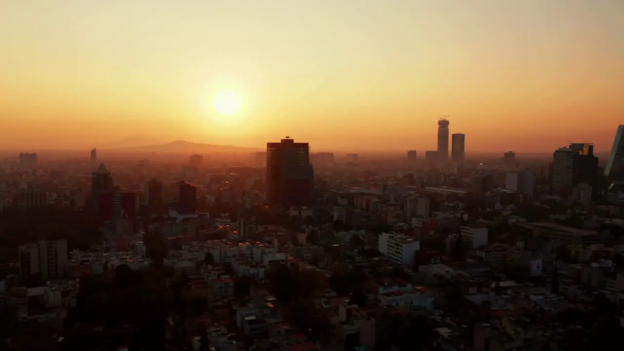 Misty sunrise scene in Mexico City slow aerial drone lateral fly