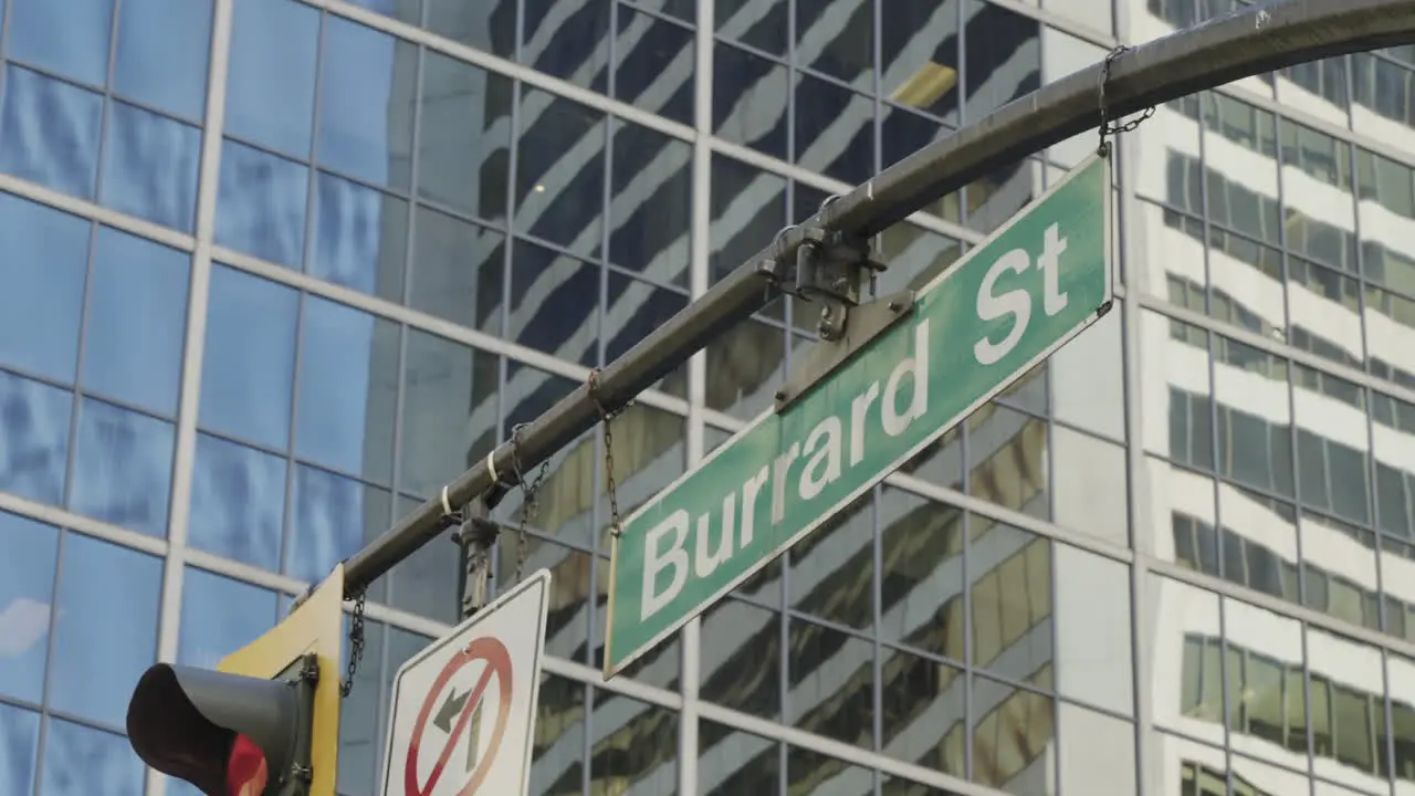 Burrard Street crossing in Vancouver street sign with buildings in the background handheld parallax