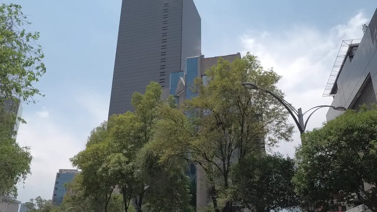 Driving on reforma avenue looking up at the buildings in Mexico City