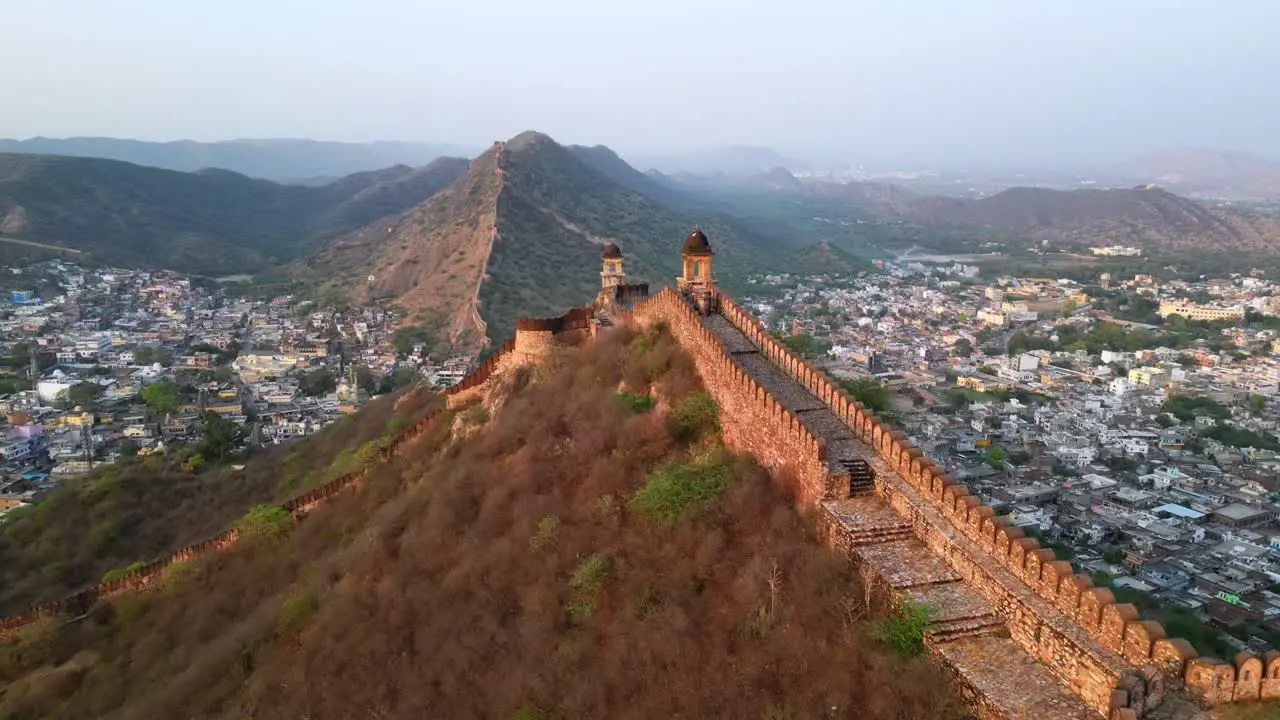 Drone shot historic city wall of Jaipur in India near Amber Fort