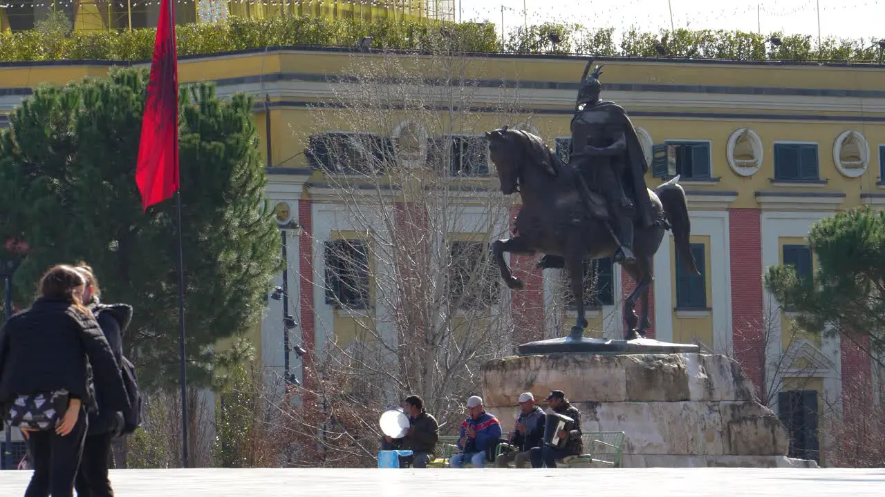 Tirana city center with people walking on main square close to Skanderbeg monument