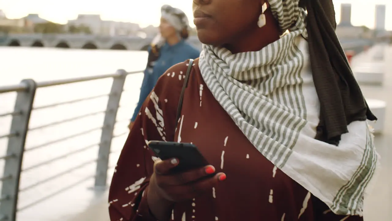 Black Woman Using Phone on Walk