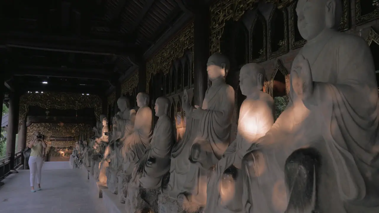 Woman taking photos of statues in Bai Dinh Pagoda Vietnam