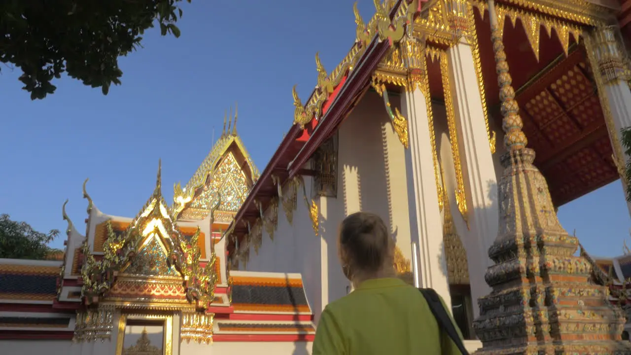 Woman visiting Buddhist Marble Temple in Bangkok Thailand