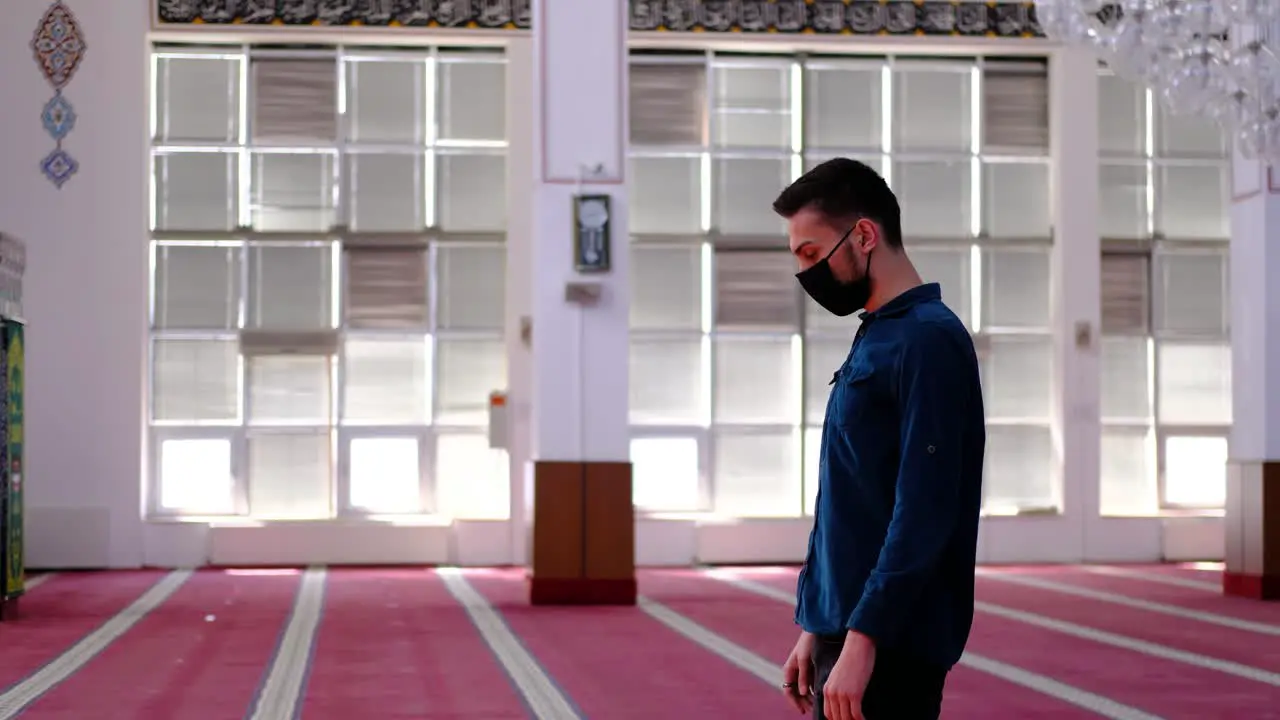 Man Worships In A Mask In A Mosque