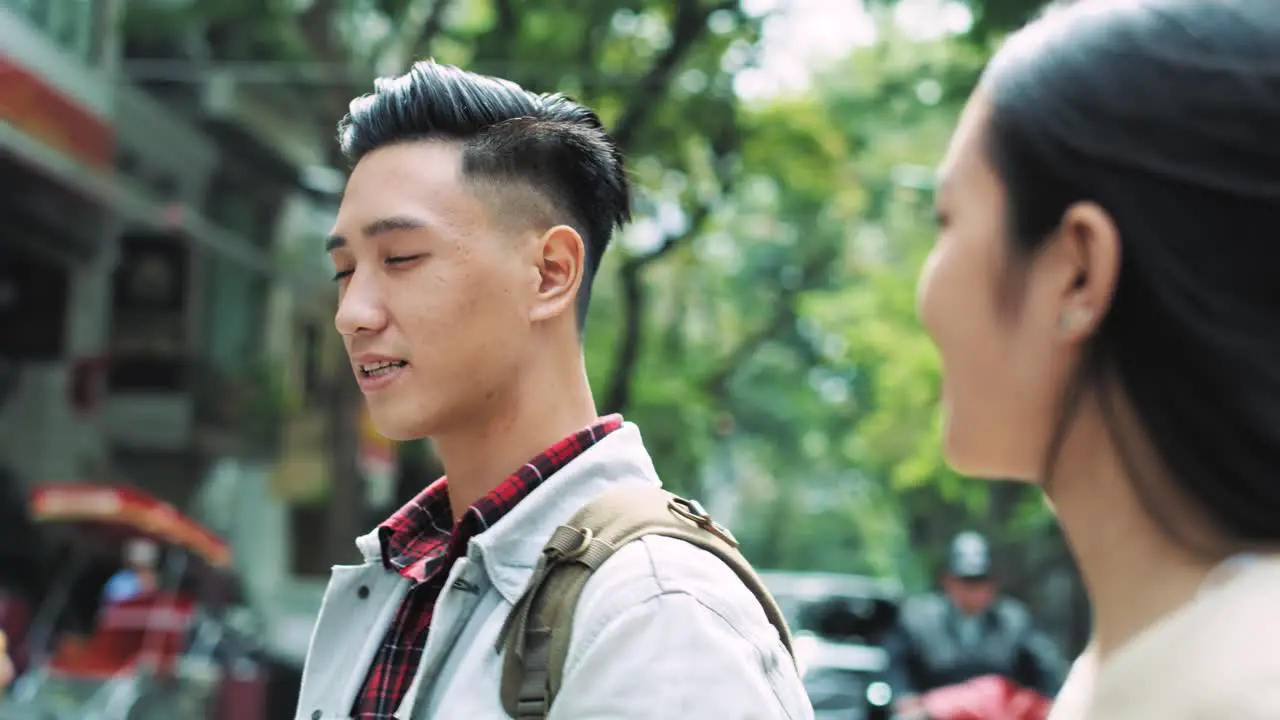 Handheld video shows of young couple walking in the city