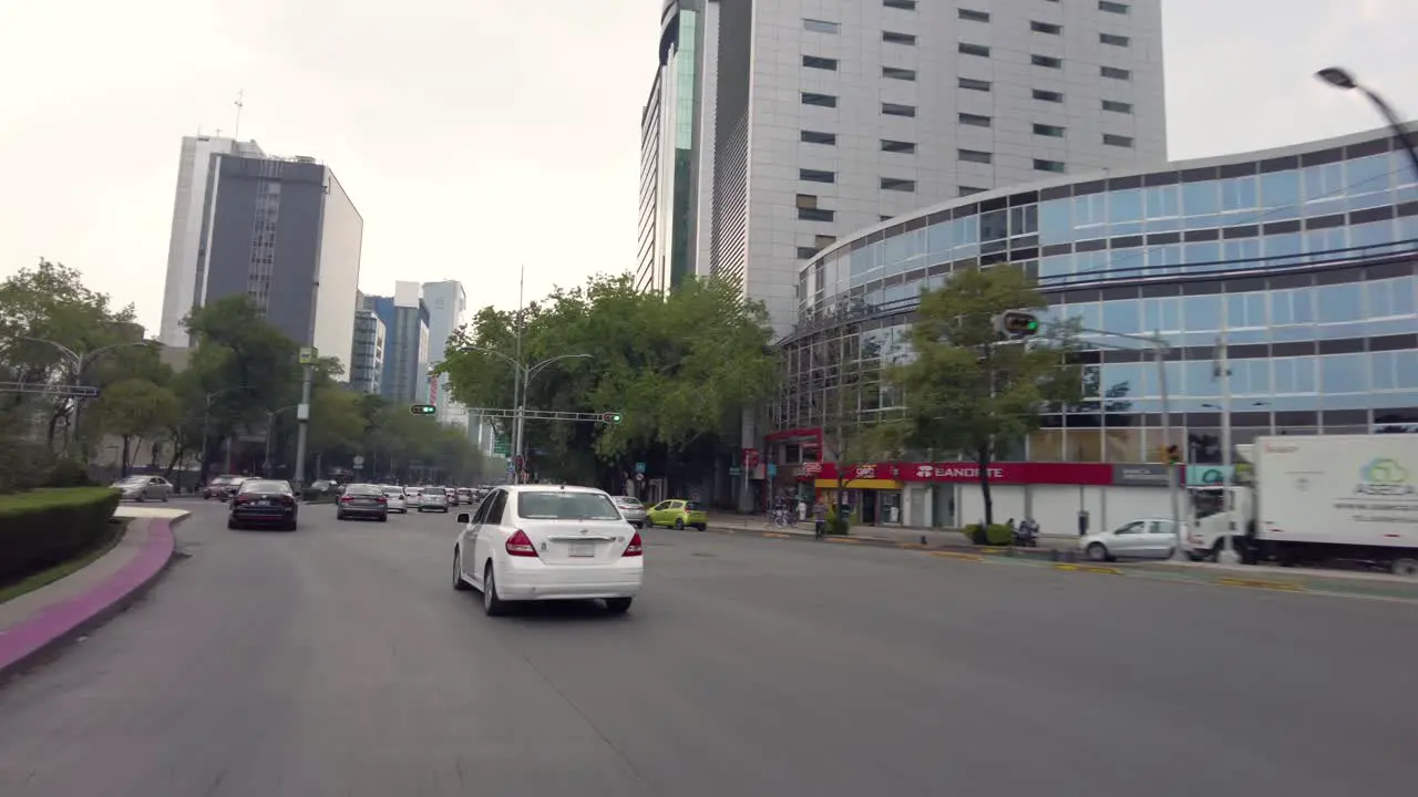 Driving through the streets of Mexico's City downtown shot from a car perspective