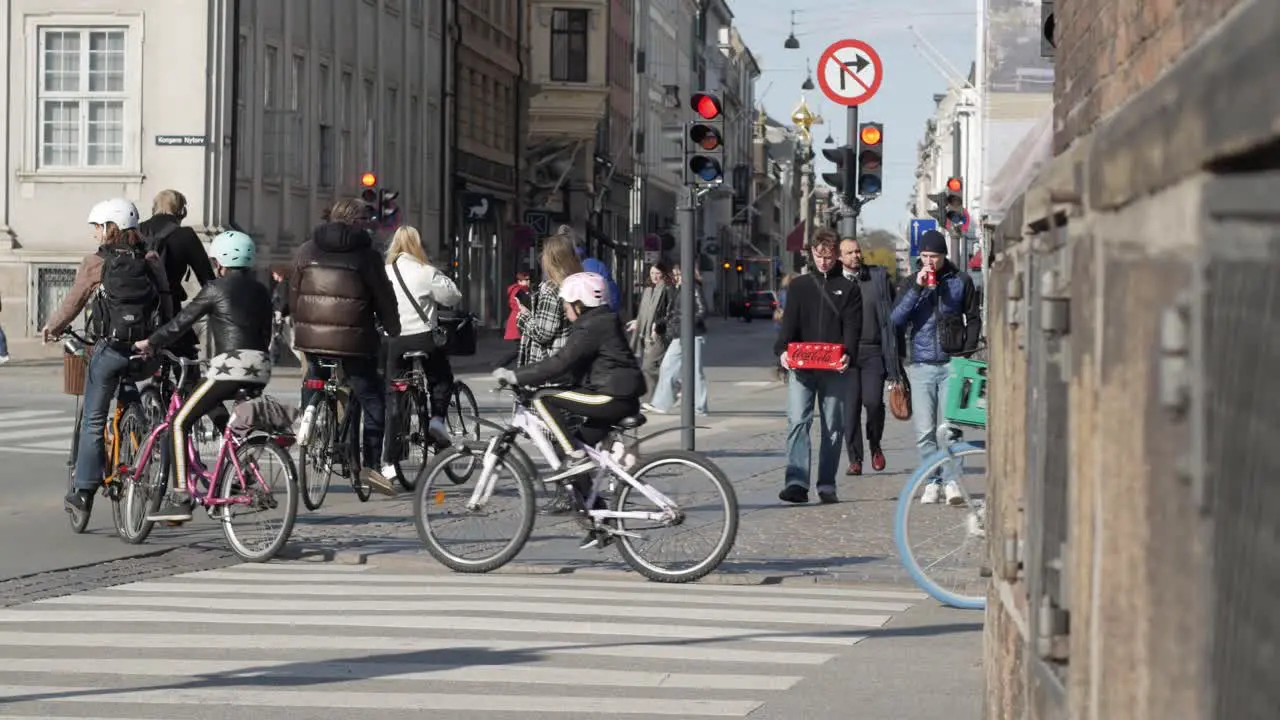 Crowd of city bikers and pedestrians on streets in Copenhagen city