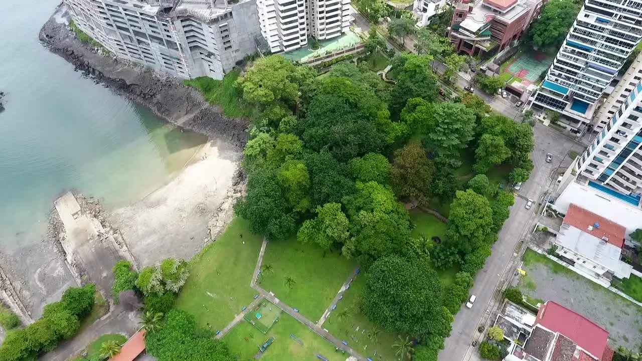 Aerial drone footage of a small park with trees in the middle of the neighborhood in Panama City